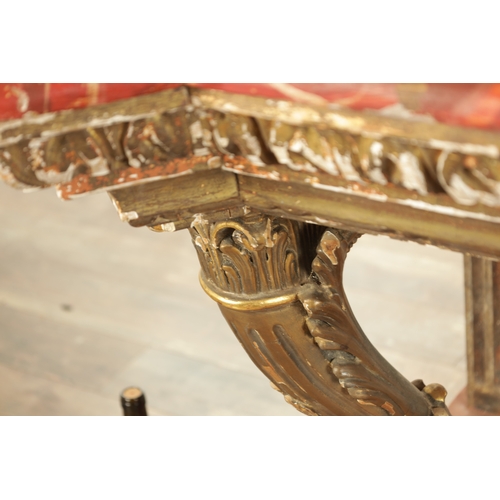 1256 - A STYLISH PAIR OF CARVED GILTWOOD AND SCUMBLED MARBLE CONSOLE TABLES having outset corners raised on... 