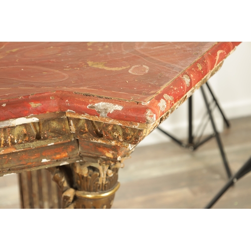 1256 - A STYLISH PAIR OF CARVED GILTWOOD AND SCUMBLED MARBLE CONSOLE TABLES having outset corners raised on... 