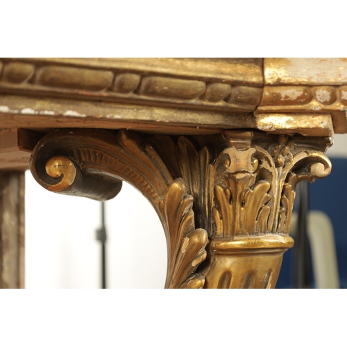 1256 - A STYLISH PAIR OF CARVED GILTWOOD AND SCUMBLED MARBLE CONSOLE TABLES having outset corners raised on... 