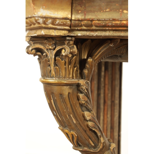 1256 - A STYLISH PAIR OF CARVED GILTWOOD AND SCUMBLED MARBLE CONSOLE TABLES having outset corners raised on... 