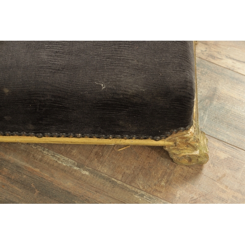 1261 - A 19TH CENTURY CARVED GILT WOOD LONG FOOT STOOL with upholstered top on leaf-carved scrolled feet (1... 