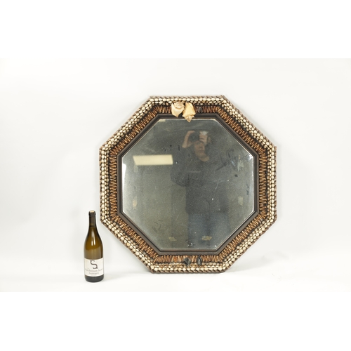 1262 - A DECORATIVE SHELLWORK HANGING MIRROR with octagonal surround and mirror plate (74cm wide )