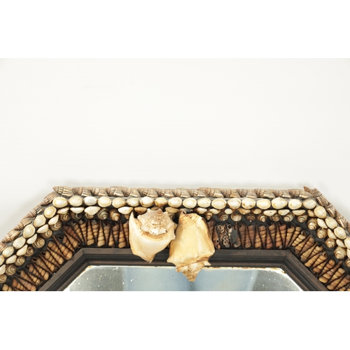 1262 - A DECORATIVE SHELLWORK HANGING MIRROR with octagonal surround and mirror plate (74cm wide )