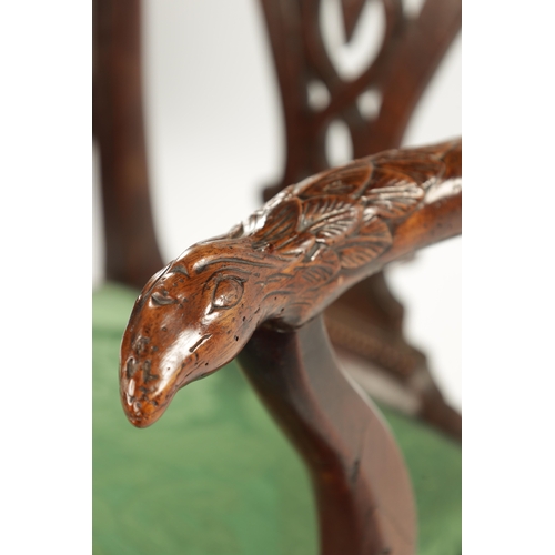 1263 - AN 18TH CENTURY WALNUT OPEN ARM CHAIR the carved eared top rail above a tassel tied shaped and fret ... 