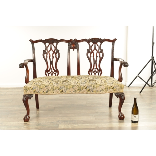 1267 - A 19TH CENTURY CARVED MAHOGANY CHIPPENDALE STYLE TWO SEATER SETTEE with leaf-carved pierced scrolled... 