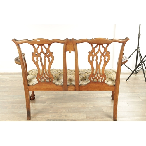 1267 - A 19TH CENTURY CARVED MAHOGANY CHIPPENDALE STYLE TWO SEATER SETTEE with leaf-carved pierced scrolled... 