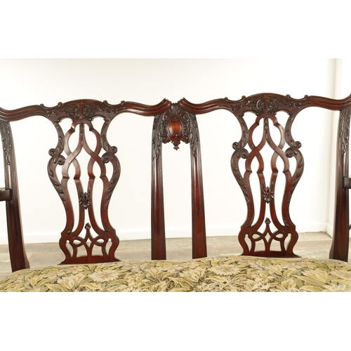 1267 - A 19TH CENTURY CARVED MAHOGANY CHIPPENDALE STYLE TWO SEATER SETTEE with leaf-carved pierced scrolled... 