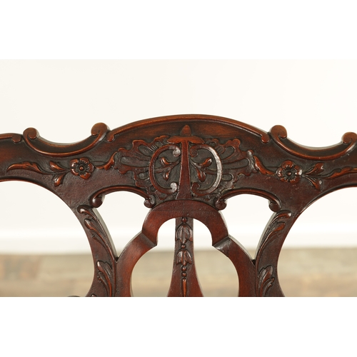 1267 - A 19TH CENTURY CARVED MAHOGANY CHIPPENDALE STYLE TWO SEATER SETTEE with leaf-carved pierced scrolled... 