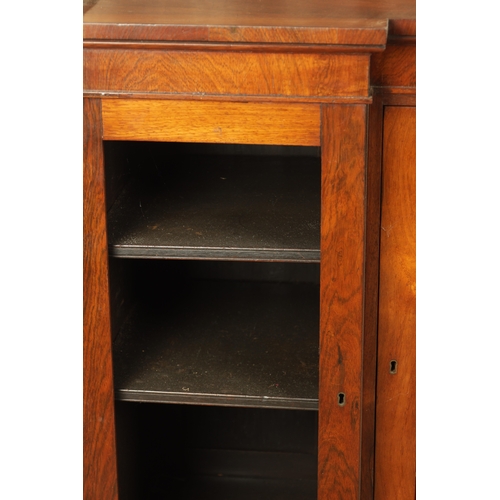 1269 - A LATE REGENCY ROSEWOOD SIDE CABINET with an inverted front having three hinged doors, the centre wi... 