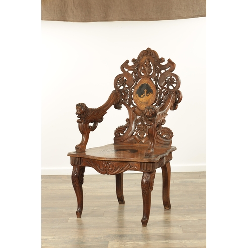 1272 - A 19TH CENTURY CARVED WALNUT AND MARQUETRY INLAID BLACK FOREST ARMCHAIR having lions head arm suppor... 