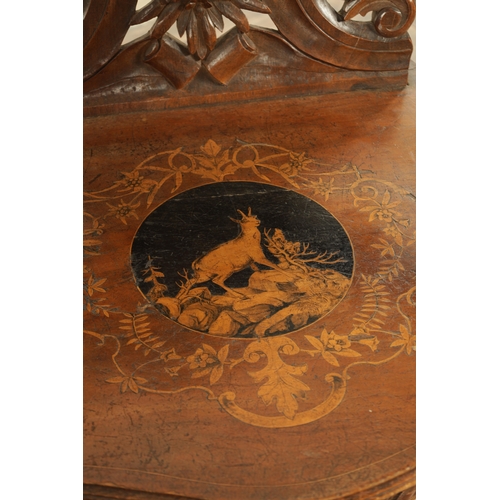 1272 - A 19TH CENTURY CARVED WALNUT AND MARQUETRY INLAID BLACK FOREST ARMCHAIR having lions head arm suppor... 