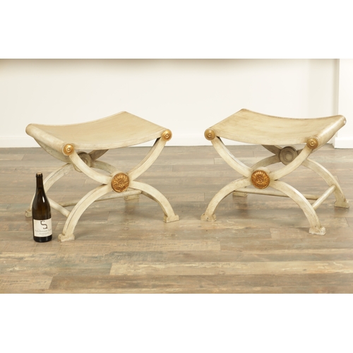 1275 - A DECORATIVE PAIR OF REGENCY STYLE PAINTED STOOLS with dished tops and X frame bases (52cm wide 43cm... 