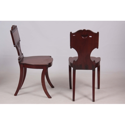 1280 - A PAIR OF REGENCY MAHOGANY HALL CHAIRS with scrolled carved backs and painted coats of arms to the p... 