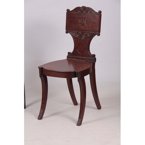 1280 - A PAIR OF REGENCY MAHOGANY HALL CHAIRS with scrolled carved backs and painted coats of arms to the p... 