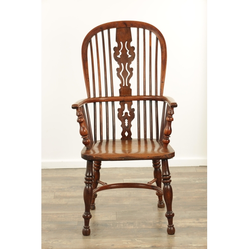 1290 - AN EARLY 19TH CENTURY NOTTINGHAMSHIRE YEW WOOD HIGH BACK WINDSOR CHAIR with hooped back and shaped p... 