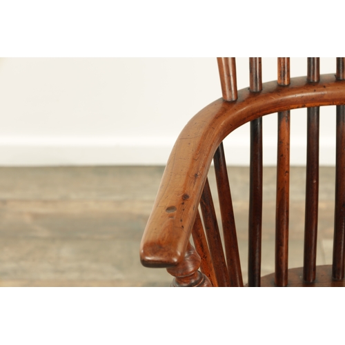 1290 - AN EARLY 19TH CENTURY NOTTINGHAMSHIRE YEW WOOD HIGH BACK WINDSOR CHAIR with hooped back and shaped p... 