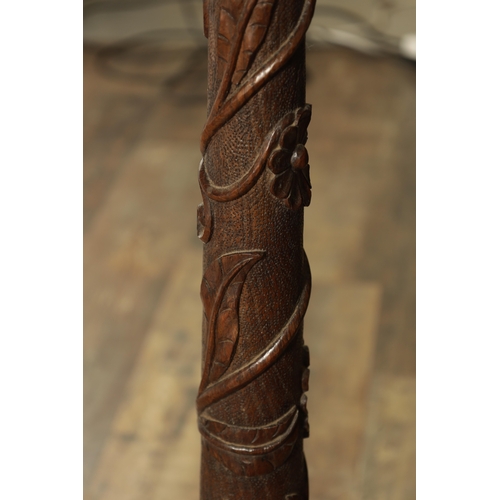 1294 - A LATE 19TH CENTURY CARVED OAK OCCASIONAL TABLE with floral and leaf work decoration (82cm high 23cm... 