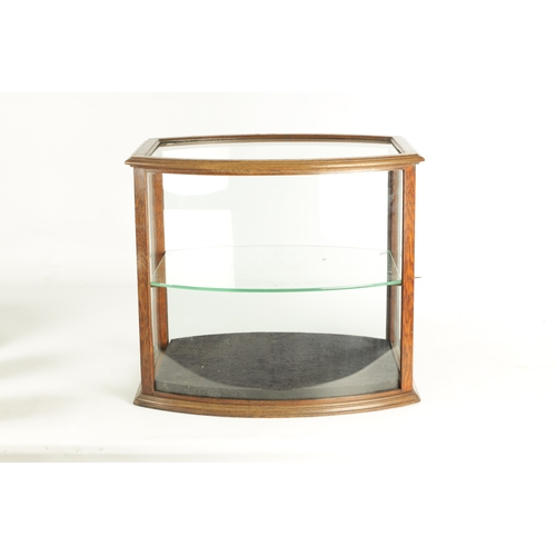 1297 - AN UNUSUAL LATE 19TH CENTURY OAK FRAME-SIDED STANDING GLAZED DISPLAY CASE with a hinged end door and... 