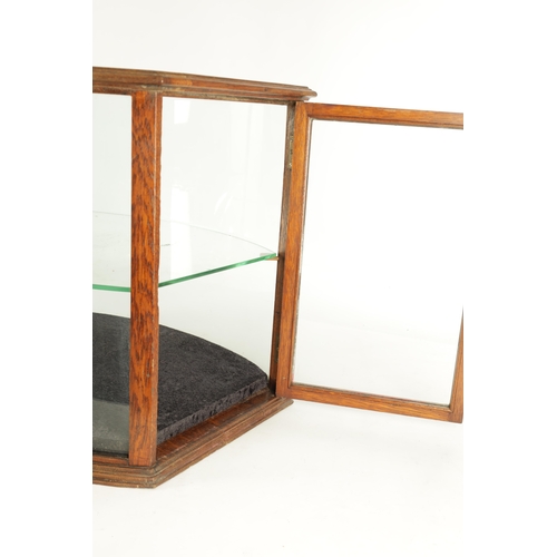 1297 - AN UNUSUAL LATE 19TH CENTURY OAK FRAME-SIDED STANDING GLAZED DISPLAY CASE with a hinged end door and... 