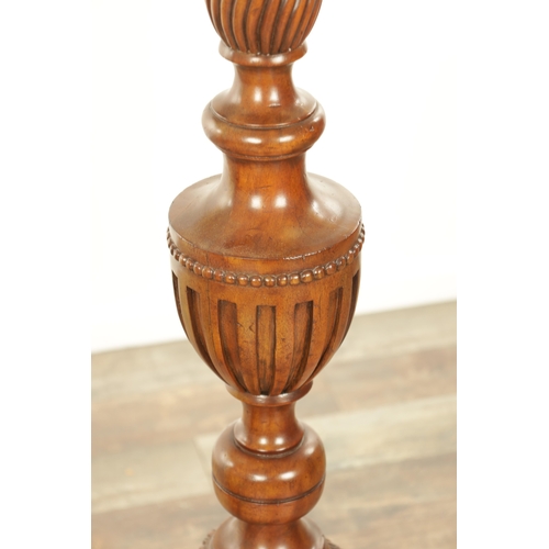 1304 - A PAIR OF 20TH CENTURY WALNUT TORCHERES with bulbous turned stem and raised on triform bases with cl... 