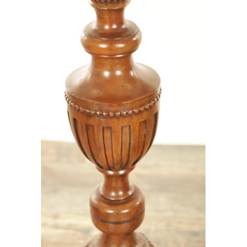 1304 - A PAIR OF 20TH CENTURY WALNUT TORCHERES with bulbous turned stem and raised on triform bases with cl... 