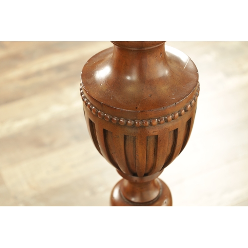 1304 - A PAIR OF 20TH CENTURY WALNUT TORCHERES with bulbous turned stem and raised on triform bases with cl... 