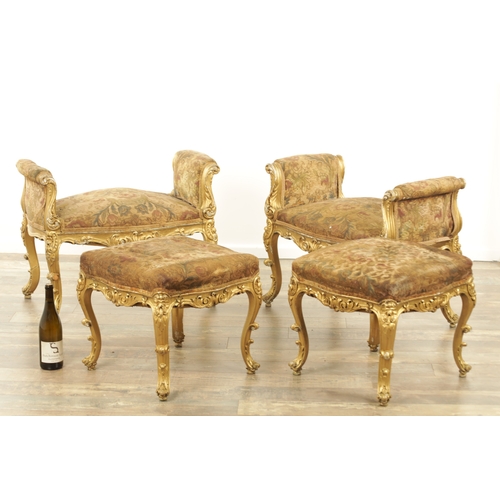 1305 - A SUITE OF FOUR CARVED GILTWOOD ROCOCO STYLE STOOLS comprising two window seats and two square stool... 