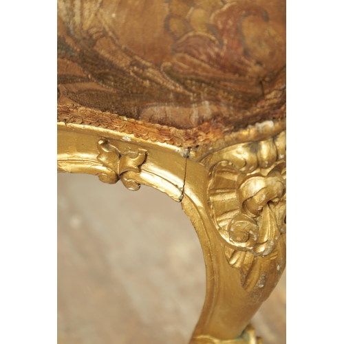 1305 - A SUITE OF FOUR CARVED GILTWOOD ROCOCO STYLE STOOLS comprising two window seats and two square stool... 