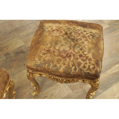 1305 - A SUITE OF FOUR CARVED GILTWOOD ROCOCO STYLE STOOLS comprising two window seats and two square stool... 