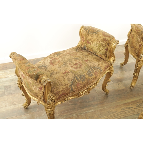 1305 - A SUITE OF FOUR CARVED GILTWOOD ROCOCO STYLE STOOLS comprising two window seats and two square stool... 