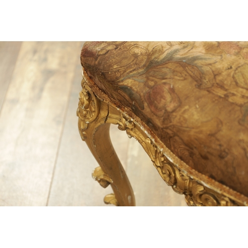 1305 - A SUITE OF FOUR CARVED GILTWOOD ROCOCO STYLE STOOLS comprising two window seats and two square stool... 