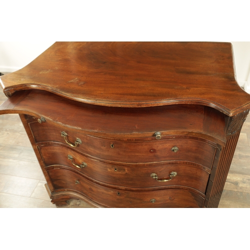 1312 - A GEORGE III MAHOGANY SERPENTINE CHEST OF DRAWERS with leaf-carved stop fluted corners enclosing a b... 