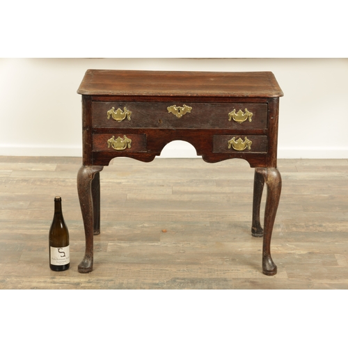 1316 - A GEORGE III OAK LOWBOY with a cross-banded top above three frieze drawers fitted with brass solid h... 