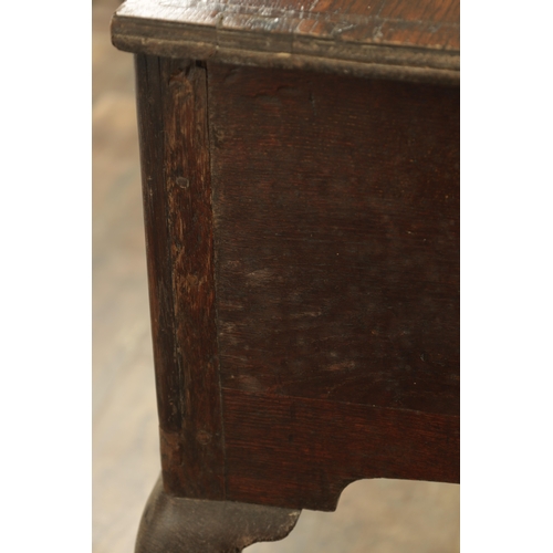 1316 - A GEORGE III OAK LOWBOY with a cross-banded top above three frieze drawers fitted with brass solid h... 