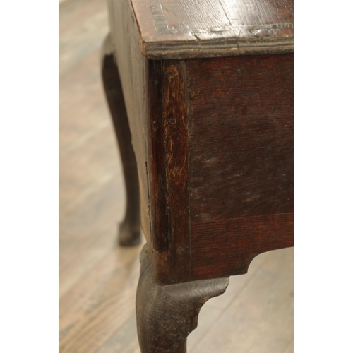 1316 - A GEORGE III OAK LOWBOY with a cross-banded top above three frieze drawers fitted with brass solid h... 