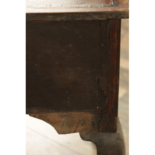 1316 - A GEORGE III OAK LOWBOY with a cross-banded top above three frieze drawers fitted with brass solid h... 