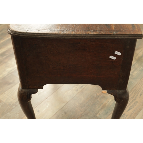 1316 - A GEORGE III OAK LOWBOY with a cross-banded top above three frieze drawers fitted with brass solid h... 