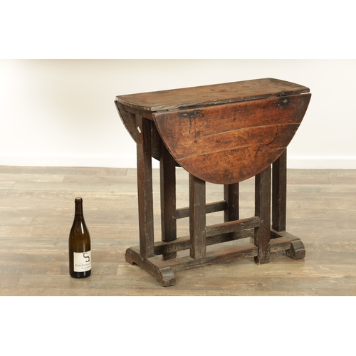 1324 - A 17TH CENTURY WALNUT GATE LEG TABLE OF SMALL SIZE with drop-down sides and joined base with hinged ... 