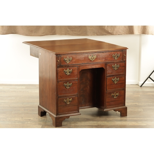 1325 - AN UNUSUAL GEORGE III MAHOGANY KNEEHOLE DESK having a drop-down top with graduated drawers fitted wi... 