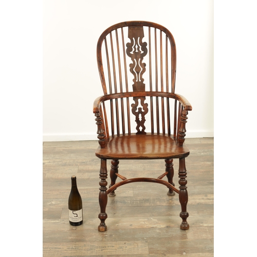 1331 - AN EARLY 19TH CENTURY NOTTINGHAMSHIRE YEW WOOD HIGH BACK WINDSOR CHAIR with hooped back and shaped p... 