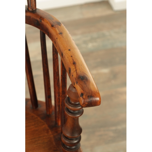 1331 - AN EARLY 19TH CENTURY NOTTINGHAMSHIRE YEW WOOD HIGH BACK WINDSOR CHAIR with hooped back and shaped p... 