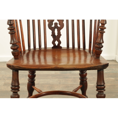 1331 - AN EARLY 19TH CENTURY NOTTINGHAMSHIRE YEW WOOD HIGH BACK WINDSOR CHAIR with hooped back and shaped p... 