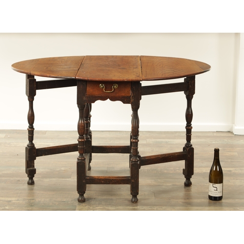 1334 - AN EARLY 18TH CENTURY JOINED ELM AND OAK GATELEG TABLE the richly figured oval drop leaf top above a... 