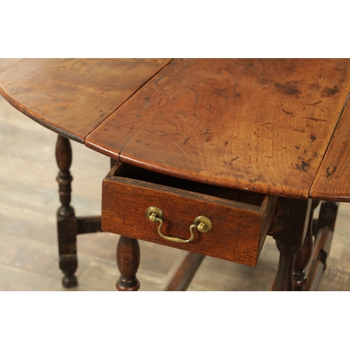 1334 - AN EARLY 18TH CENTURY JOINED ELM AND OAK GATELEG TABLE the richly figured oval drop leaf top above a... 