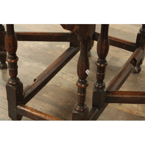 1334 - AN EARLY 18TH CENTURY JOINED ELM AND OAK GATELEG TABLE the richly figured oval drop leaf top above a... 