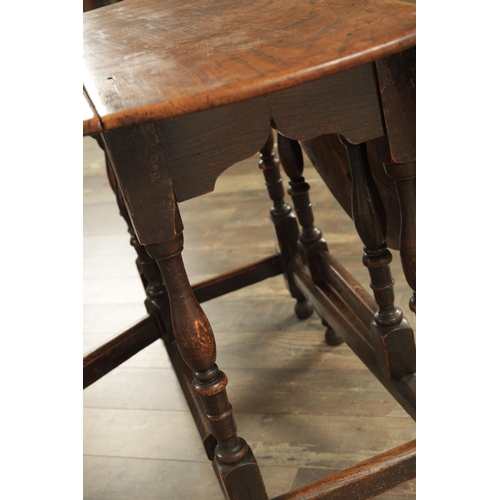 1334 - AN EARLY 18TH CENTURY JOINED ELM AND OAK GATELEG TABLE the richly figured oval drop leaf top above a... 