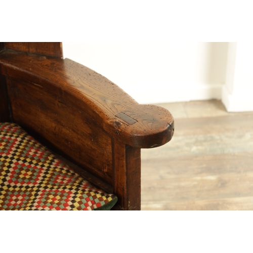 1341 - A MID 18TH CENTURY FRUITWOOD AND PINE LAMBING CHAIR with panelled winged back above a rope seat and ... 