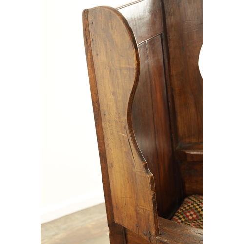 1341 - A MID 18TH CENTURY FRUITWOOD AND PINE LAMBING CHAIR with panelled winged back above a rope seat and ... 