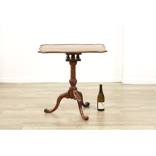 1349 - A GEORGE III MAHOGANY SERPENTINE TILT TOP TABLE with tapering fluted stem above a shaped carved cabr... 