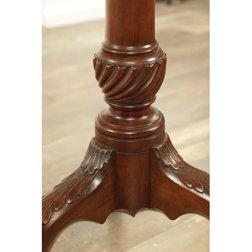 1349 - A GEORGE III MAHOGANY SERPENTINE TILT TOP TABLE with tapering fluted stem above a shaped carved cabr... 